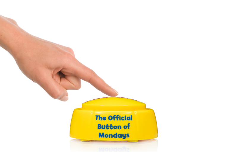 Front view of yellow Dammit Button showing full The Official Button of Mondays slogan